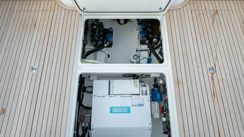 Slide: The Image of Engine Room Access with Teak Deck This image showcases the easily accessible engine room of the 2022 Valhalla Boatworks V-46, featuring a neatly organized layout. The teak decking provides a luxurious and practical surface, adding to the vessel's elegance while ensuring durability. The vi - 7162296