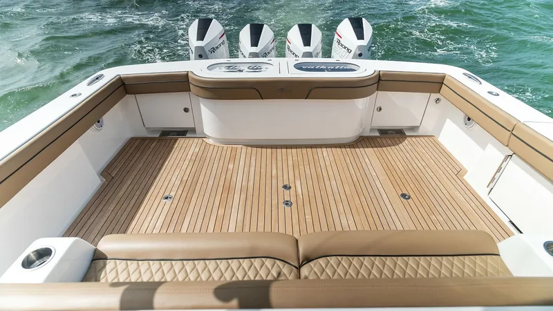 Slide: The Image of Spacious Aft Deck with Seating The aft deck of the MarMar V-46 showcases a spacious and elegant layout, featuring premium teak decking and plush, diamond-stitched seating. This area is perfect for relaxation or entertaining, with ample room for guests to enjoy the open water views. The - 6845062