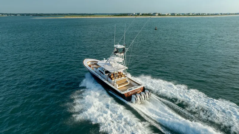 Slide: The Image of Aerial View of Aft Deck and Engines This dynamic image showcases the aft deck of the 2022 Valhalla Boatworks V-46, named MarMar, as it powers through the water. The sleek design is complemented by powerful outboard engines, ensuring high performance and speed. The spacious deck offers ample - 7162321