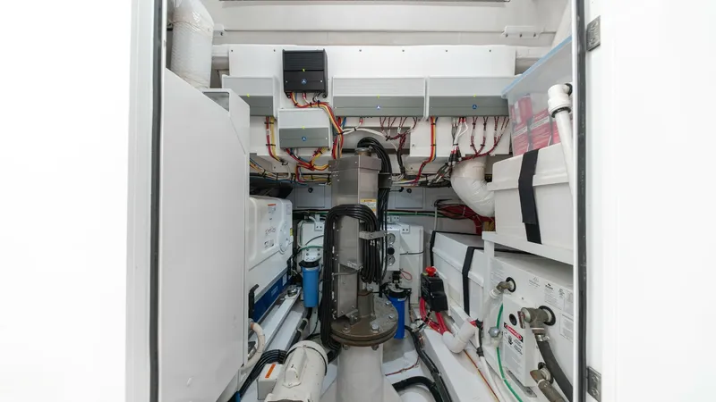 Slide: The Image of Engine Room with Modern Systems The engine room of the MarMar V-46 by Valhalla Boatworks showcases a meticulously organized space with advanced mechanical systems. It features state-of-the-art equipment, neatly arranged wiring, and efficient use of space to ensure optimal performance. T - 7162315