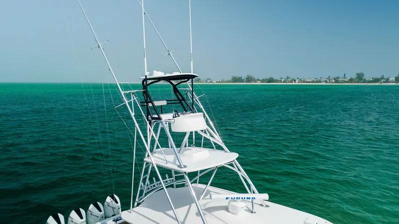 Slide: The Image of Flybridge with Tower Seating This image showcases the sleek flybridge of the 2022 Valhalla V-46, featuring a tower with dual seating. The structure is designed for optimal visibility, perfect for sportfishing or leisurely cruises. The stainless steel framework and cushioned seating h - 6845087