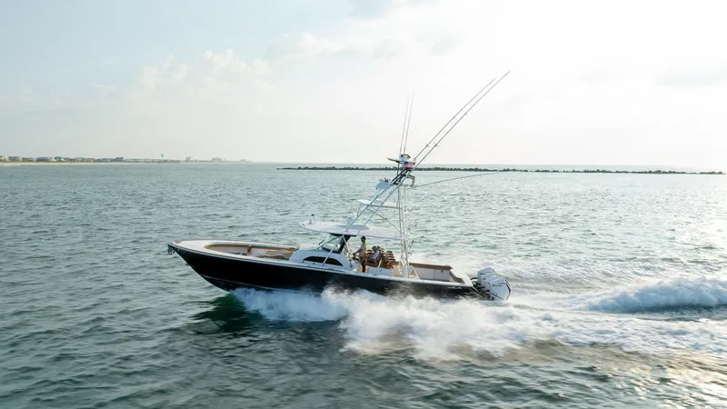 Slide: The Image of Side View of Valhalla V-46 in Motion This dynamic side view captures the sleek design of the 2022 Valhalla V-46 by Valhalla Boatworks. The vessel is shown cutting through the water with precision, showcasing its powerful outboard engines and elegant hull design. The spacious deck and state-o - 7162326