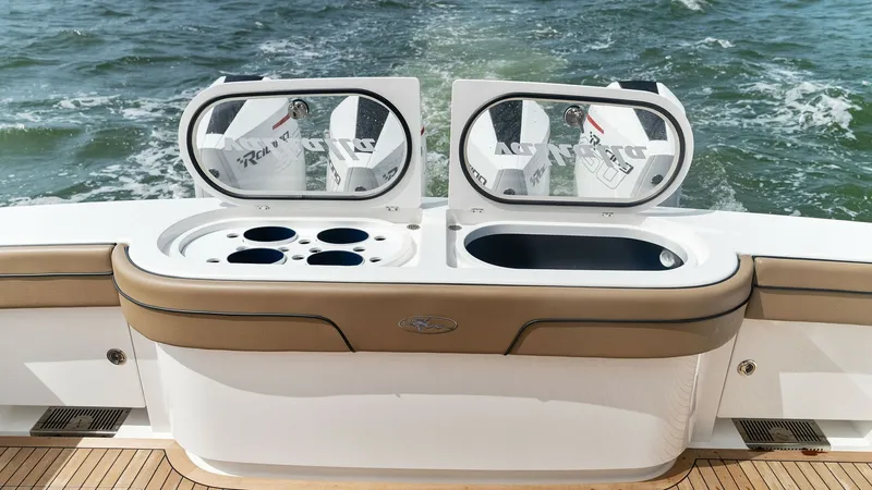 Slide: The Image of Aft Deck with Livewell Station The aft deck of the MarMar V-46 features a well-appointed livewell station, perfect for serious anglers. With integrated cup holders and sleek, easy-to-clean surfaces, this area offers both functionality and style. The teak decking adds a touch of eleganc - 6845073