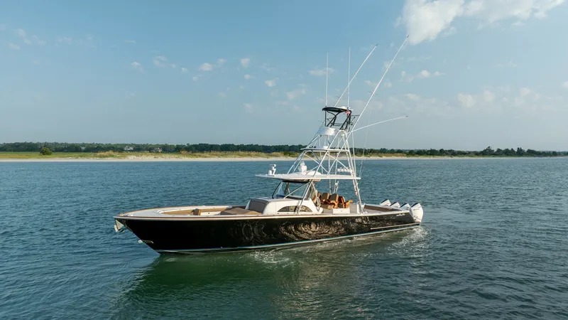 Slide: The Image of Side Profile of Valhalla V-46 This image showcases the sleek side profile of the 2022 Valhalla V-46 by Valhalla Boatworks. The vessel features a striking black hull, complemented by a spacious deck and a robust tower for optimal visibility. Its elegant design and powerful presence mak - 7162318