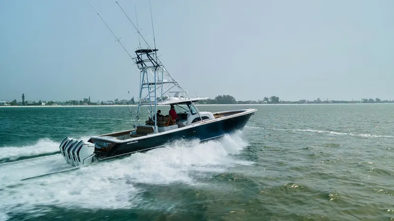 Slide: The Image of Valhalla V-46 in Action The Valhalla V-46, manufactured in 2022, showcases its sleek design and powerful performance as it cruises through open waters. Equipped with multiple outboard engines, this vessel offers impressive speed and agility. The elevated tower and spacious deck - 6845093