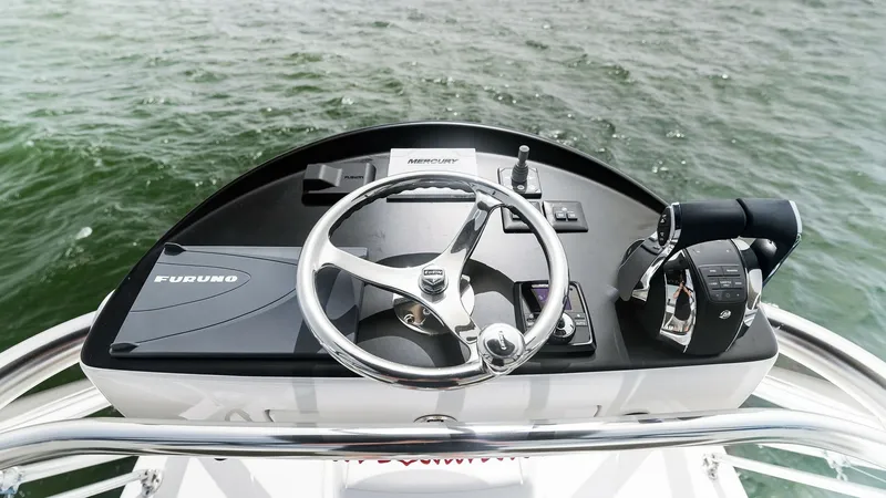 Slide: The Image of Helm Station with Navigation Controls The helm station of the 2022 Valhalla Boatworks V-46 offers a sleek and functional design. Featuring a polished steering wheel, advanced navigation systems, and intuitive throttle controls, it ensures precise handling and easy maneuverability. The ergonom - 6845076