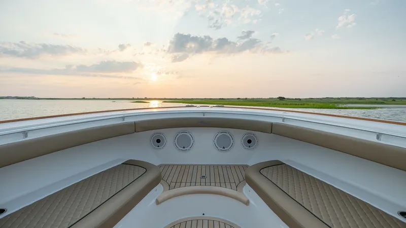 Slide: The Image of Spacious Bow Seating Area The bow of the 2022 Valhalla V-46 features elegant, cushioned seating with ample space for relaxation and socializing. The premium teak decking complements the sleek design, while the integrated speakers ensure an immersive audio experience. Enjoy panoram - 7162282