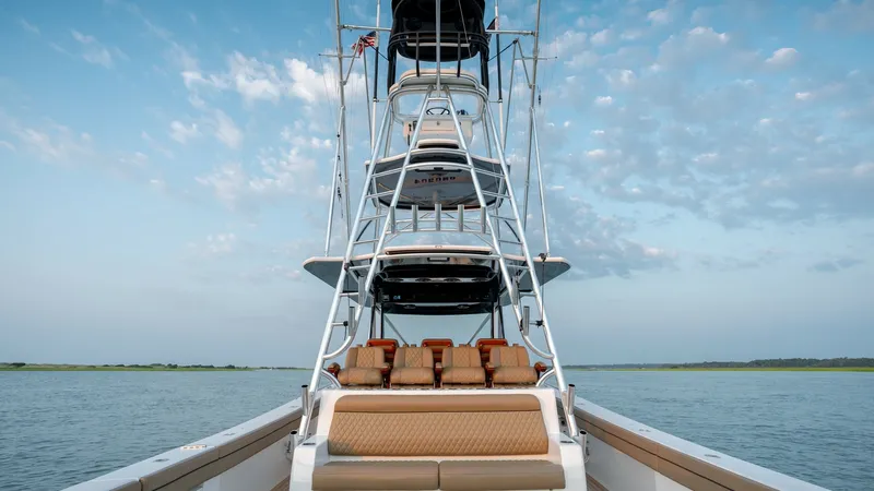 Slide: The Image of Tower and Aft Seating Area This image showcases the impressive tower structure and comfortable aft seating of the 2022 Valhalla V-46 by Valhalla Boatworks. The tower offers excellent visibility and is complemented by sleek, modern lines. The aft seating area features plush, tan uph - 7162300