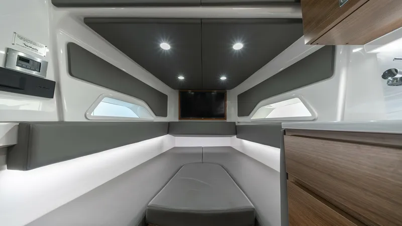 Slide: The Image of Forward Cabin with Seating Area The forward cabin of the 2022 MarMar V-46 offers a sleek and modern design with plush grey seating and ambient LED lighting. The cabin is adorned with wood accents and features porthole windows that provide natural light. This inviting space is perfect fo - 7162309