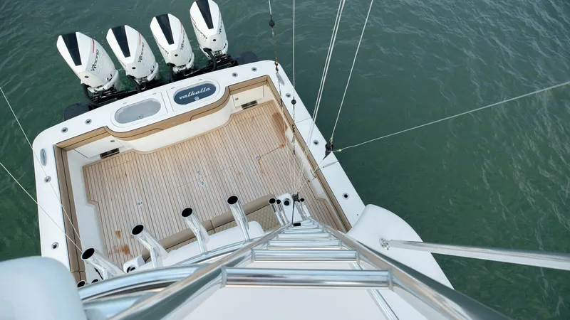 Slide: The Image of Aerial View of Aft Deck This aerial shot of the V-46's aft deck highlights the spacious, teak-lined cockpit, perfect for fishing or leisure. The quad outboard engines promise exceptional performance, while the integrated rod holders and livewell cater to avid anglers. The overal - 7162307