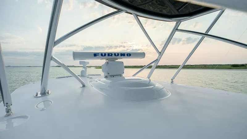 Slide: The Image of Helm Radar and Hardtop View This image showcases the sleek design of the V-46's helm area, featuring a Furuno radar system mounted atop a sturdy hardtop. The elegant framework provides a robust structure while offering an unobstructed panoramic view of the surrounding waters. Ideal - 7162305