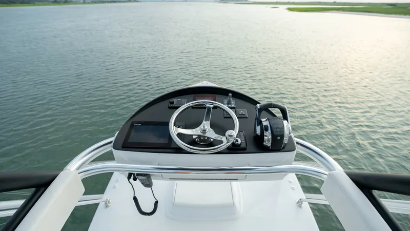 Slide: The Image of Flybridge Helm Station This image showcases the sleek flybridge helm station aboard the MarMar, a 2022 Valhalla Boatworks V-46. The helm is equipped with modern navigation instruments and a sleek steering wheel, offering commanding views of the surrounding waters. The well-desi - 7162302