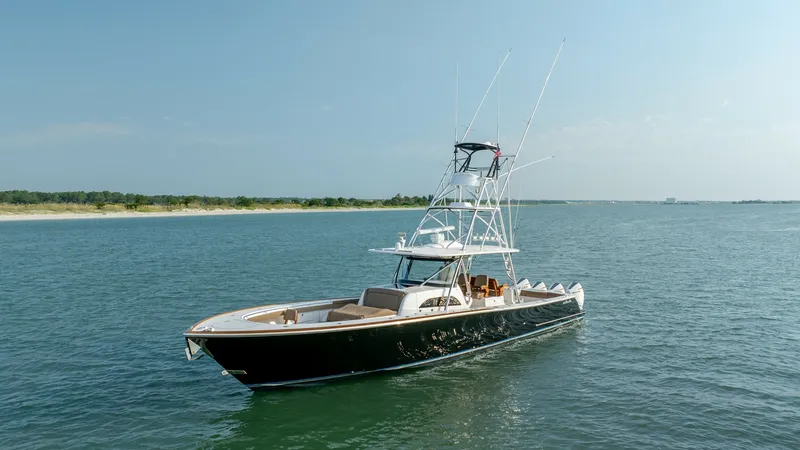 Slide: The Image of Starboard View with Tower and Cockpit The MarMar V-46 by Valhalla Boatworks showcases its sleek design from the starboard side, highlighting the robust tuna tower and spacious cockpit. The vessel's elegant black hull contrasts beautifully with the light teak accents on the deck, enhancing its - 7162320