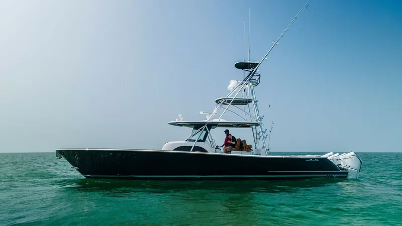 Slide: The Image of Side Profile of V-46 Center Console This image showcases the sleek side profile of the 2022 Valhalla Boatworks V-46. The vessel's elegant lines and robust construction are complemented by a spacious center console, perfect for both leisure and sport fishing. The triple outboard engines prom - 6845083