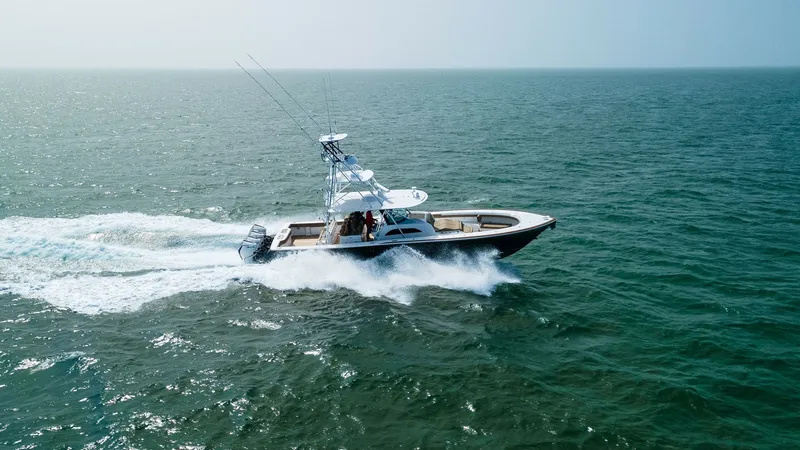 Slide: The Image of Aerial View of V-46 in Motion The 2022 Valhalla Boatworks V-46, named MarMar, is captured slicing through the open sea with elegance and power. This aerial shot showcases the vessel's sleek design and robust hull, perfect for both fishing and leisure cruising. The spacious deck and ad - 6845092