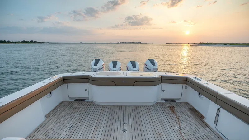Slide: The Image of Spacious Aft Deck with Seating The MarMar's aft deck features ample seating, perfect for relaxation and socializing while enjoying the breathtaking sunset views. The teak flooring adds a touch of elegance and durability, complementing the sleek design. With powerful outboard engines, t - 7162292