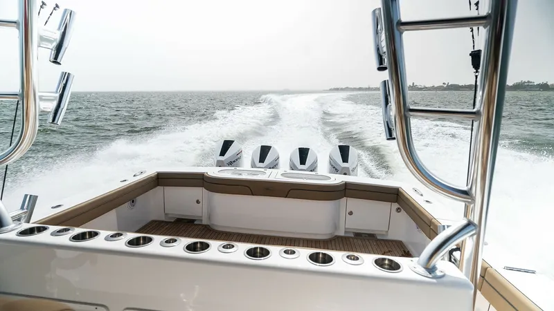 Slide: The Image of Stern View with Quad Outboards The stern of the Valhalla Boatworks V-46 showcases a powerful quad outboard engine setup, perfect for high-speed cruising. The spacious aft deck features ample seating and well-placed rod holders, ideal for fishing enthusiasts. The sleek design and high-q - 6845075