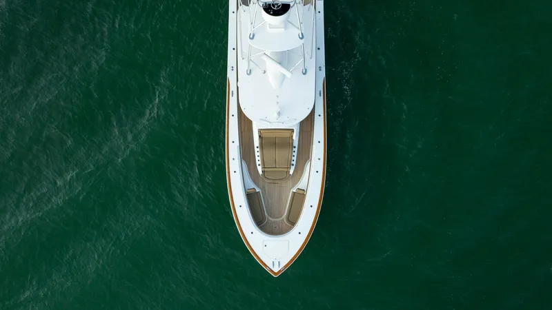 Slide: The Image of Aerial View of Bow Deck This image showcases the sleek bow of the MarMar V-46 by Valhalla Boatworks, highlighting its elegant teak decking and spacious sun pad. The streamlined design offers both style and functionality, perfect for sunbathing or enjoying panoramic views. The ve - 7162334