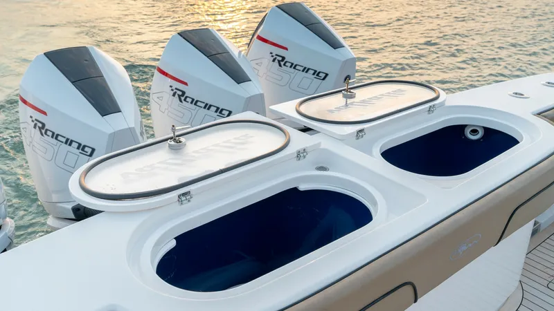 Slide: The Image of Aft Deck with Livewells and Engines This image showcases the aft deck of the 2022 MarMar V-46 by Valhalla Boatworks, featuring dual livewells perfect for avid anglers. The sleek design is complemented by powerful racing outboard engines, promising both speed and efficiency. The sunset backd - 7162294