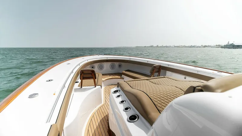 Slide: The Image of Spacious Bow Seating Area The bow of the 2022 MarMar V-46 by Valhalla Boatworks showcases a luxurious seating area with elegant, quilted upholstery, perfect for relaxation and enjoyment. The teak decking adds a touch of sophistication, complementing the sleek lines of the vessel. - 6845063