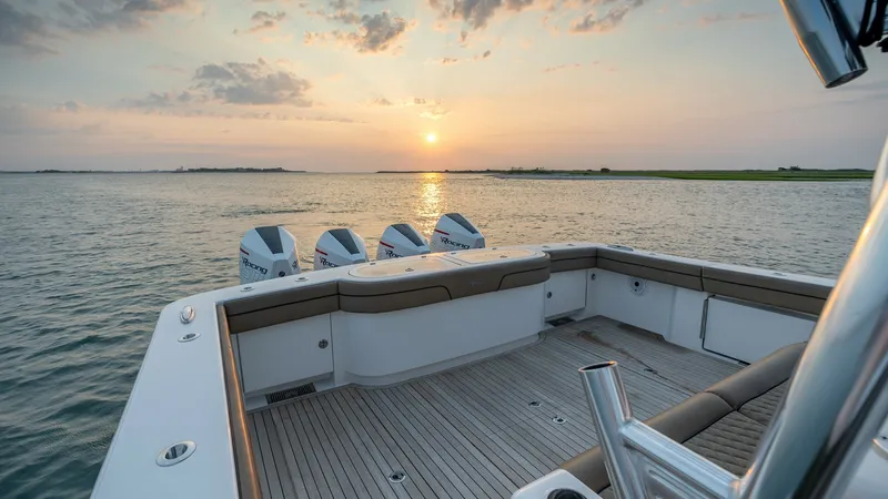 Slide: The Image of Spacious Aft Deck with Sunset View The aft deck of the 2022 Valhalla Boatworks V-46, MarMar, showcases a generous layout perfect for relaxation and entertaining. Featuring premium teak flooring and cushioned seating, this area offers comfort combined with practicality. The stunning sunset - 7162291