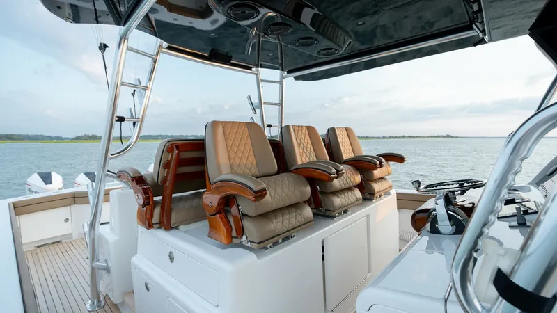 Slide: The Image of Helm Seating and Console Area The helm area of the MarMar V-46 by Valhalla Boatworks features luxurious, cushioned captain chairs with elegant wood accents, offering both comfort and style. The clean, modern console is equipped with state-of-the-art navigation technology, ensuring a s - 7162288