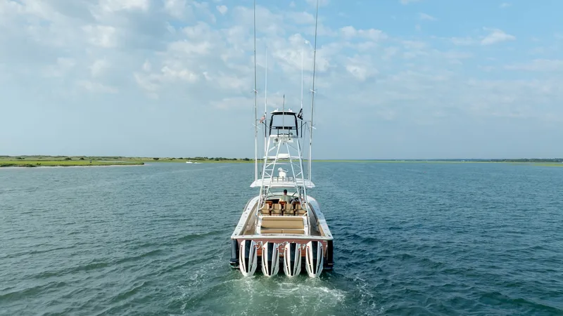 Slide: The Image of Aft View with Triple Engines This image showcases the sleek aft view of the 2022 Valhalla V-46 by Valhalla Boatworks. Prominent are the triple outboard engines, designed for powerful performance and efficient cruising. The spacious cockpit features plush seating, ideal for relaxation - 7162333
