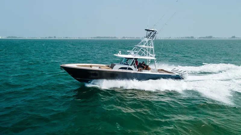 Slide: The Image of Valhalla V-46 in Motion The 2022 Valhalla V-46, named MarMar, elegantly glides through the open waters, showcasing its sleek design and powerful performance. Its modern hull and sophisticated tower highlight the vessel's prowess, making it ideal for both leisure and sport. The s - 6845089