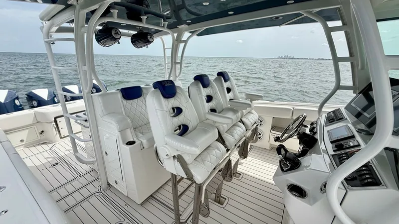 Slide: The Image of Helm and Seating Area The helm of the 2018 Hydra-Sports 4200 Siesta features four plush, ergonomic captain's chairs with quilted upholstery, providing comfort for extended journeys. The state-of-the-art dashboard is equipped with advanced navigation and control systems, ensuri - 7030822