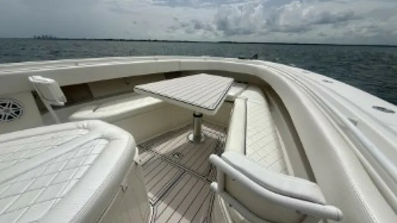 Slide: The Image of Spacious Bow Seating Area This image showcases the elegant bow seating area of the 2018 Hydra-Sports 4200 Siesta. The space features plush, diamond-stitched upholstery and a versatile table, perfect for socializing or dining. Surrounded by panoramic ocean views, this area offers b - 7030826