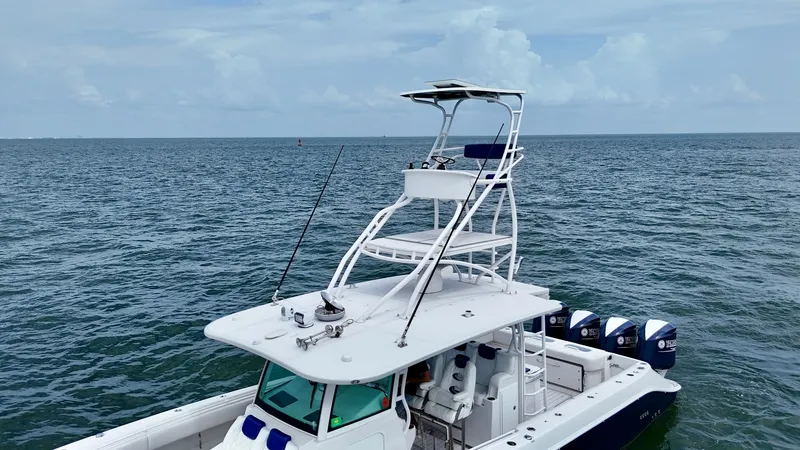 Slide: The Image of Flybridge and Helm Station This image showcases the elevated flybridge and helm station of the 2018 Hydra-Sports 4200 Siesta. The flybridge provides an excellent vantage point for navigation, equipped with a comfortable seat and canopy for sun protection. Below, the helm station fe - 7030855
