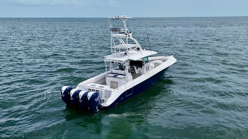 Slide: The Image of Aerial View of Aft Deck and Helm This image showcases the spacious aft deck of the 2018 Hydra-Sports 4200 Siesta, featuring a powerful quad-engine setup for superior performance. The open deck layout is complemented by a well-equipped helm station, providing excellent visibility and easy - 7030847