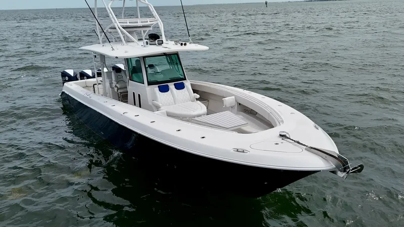 Slide: The Image of Bow View with Seating and Console The Hydra-Sports 4200 Siesta showcases a spacious bow area designed for both relaxation and practicality. Featuring plush seating with adjustable headrests, the space is complemented by a sleek center console for optimal navigation. The clean lines and hi - 7030849