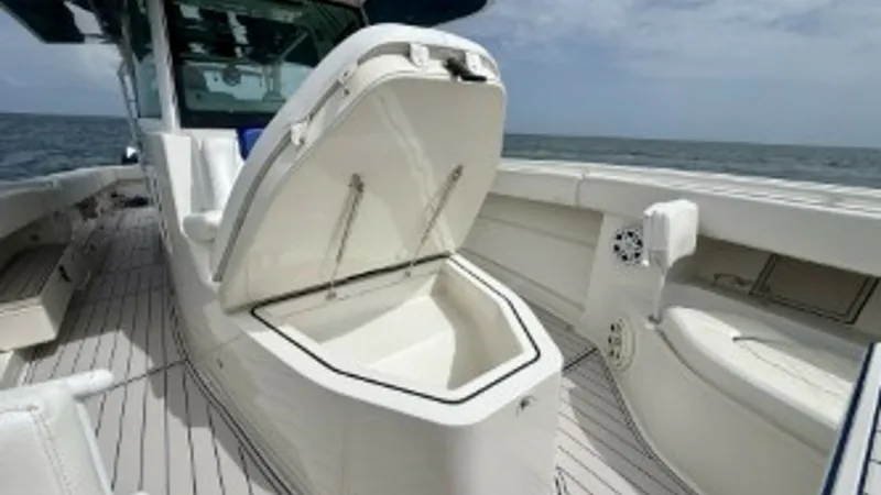 Slide: The Image of Open Deck Storage Compartment This image showcases the spacious storage compartment on the deck of the 2018 Hydra-Sports 4200 Siesta. The compartment's robust lid and clean, white finish complement the sleek design of the vessel. This feature is ideal for storing gear and keeping the - 7030824