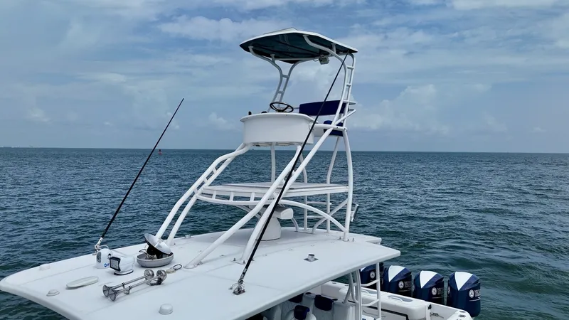 Slide: The Image of Flybridge with Helm Station The image showcases the elevated flybridge of the 2018 Hydra-Sports 4200 Siesta, offering a commanding view for navigation. The helm station is equipped with a comfortable seat and essential controls, providing an excellent vantage point for piloting. The - 7030852