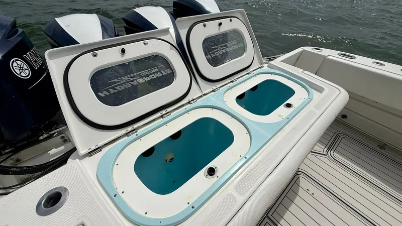 Slide: The Image of Aft Deck Livewell System This image showcases the dual livewell system on the aft deck of the 2018 Hydra-Sports 4200 Siesta. The spacious compartments are designed for optimal water circulation, ensuring your bait stays fresh. Complemented by a non-slip deck surface and easy acce - 7030838
