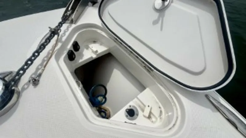Slide: The Image of Bow Anchor Locker Open The image showcases the open anchor locker on the bow of the 2018 Hydra-Sports 4200 Siesta. The locker provides ample space for storing anchor lines and accessories, with a neatly arranged chain and anchor system ensuring ease of use. The durable, non-sli - 7030829