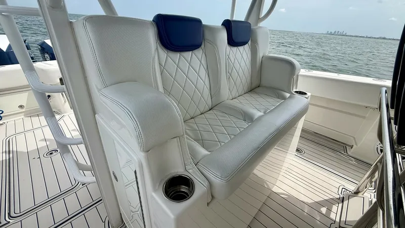 Slide: The Image of Comfortable Helm Seating Area This image showcases the luxurious helm seating area on the 2018 Hydra-Sports 4200 Siesta. The plush, diamond-stitched upholstery offers comfort and elegance, complemented by integrated cup holders for convenience. The open deck layout provides an unobstr - 7030823