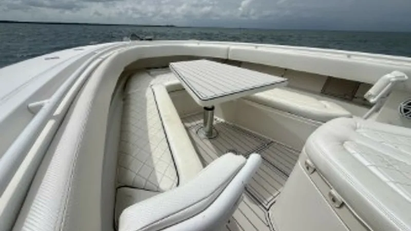 Slide: The Image of Spacious Bow Seating Area The bow of the 2018 Hydra-Sports 4200 Siesta features plush wraparound seating with elegant diamond-stitched upholstery, perfect for leisurely gatherings. A sleek, adjustable table provides a convenient spot for refreshments or dining. Surrounded by a pan - 7030827