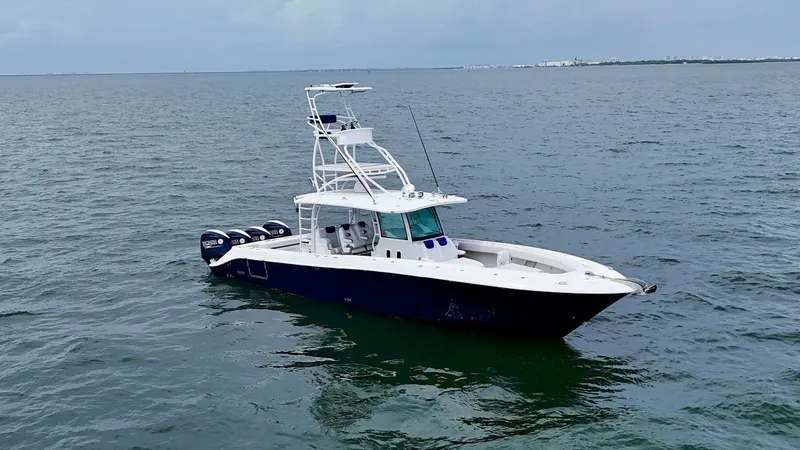 Slide: The Image of Aerial View of Center Console This image showcases the sleek design of the 2018 Hydra-Sports 4200 Siesta. The vessel features a spacious center console layout with a commanding helm station and a robust T-top for shade. Equipped with four powerful outboard engines, this yacht is desig - 7030843
