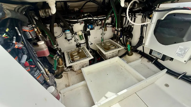 Slide: The Image of Engine Compartment with Fuel Filters This image showcases the engine compartment of the 2018 Hydra-Sports 4200 Siesta, highlighting its neatly organized fuel filters and wiring. The layout is designed for easy access and maintenance, ensuring optimal performance and reliability. The space is - 7030840
