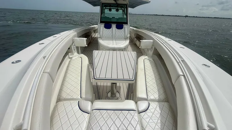Slide: The Image of Spacious Bow Seating Area This image showcases the luxurious bow seating area of the 2018 Hydra-Sports 4200 Siesta. Featuring plush, diamond-stitched upholstery, the space invites relaxation and socializing. The central table is perfect for dining or entertaining, while the open d - 7030816