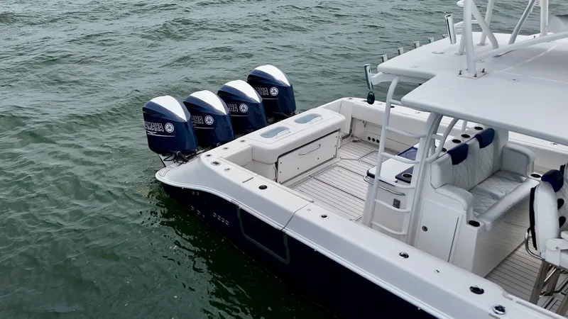 Slide: The Image of Aft Deck with Quad Engines The aft deck of the Hydra-Sports 4200 Siesta showcases a spacious layout with plush seating and practical design. Equipped with four powerful outboard engines, this vessel promises exceptional performance on the water. The elegant deck space is perfect fo - 7030850