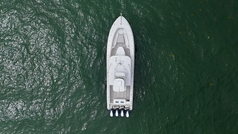 Slide: The Image of Aerial View of Hydra-Sports 4200 Siesta This aerial shot showcases the sleek design of the 2018 Hydra-Sports 4200 Siesta, featuring a spacious deck layout and modern aesthetics. The vessel is equipped with powerful outboard engines, highlighting its performance capabilities. The streamlined str - 7030858