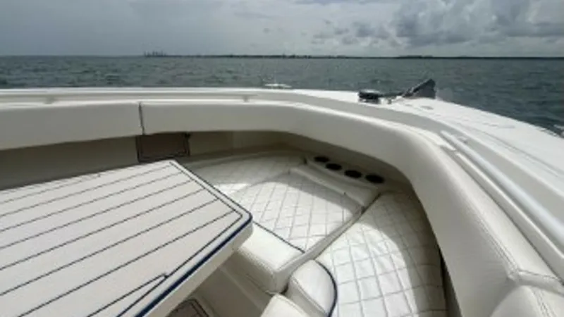Slide: The Image of Bow Seating Area with Table The 2018 Hydra-Sports 4200 Siesta features a spacious bow seating area with plush, diamond-stitched upholstery, offering comfort and style. The integrated table is perfect for entertaining or enjoying meals with a stunning ocean view. This area highlights - 7030825