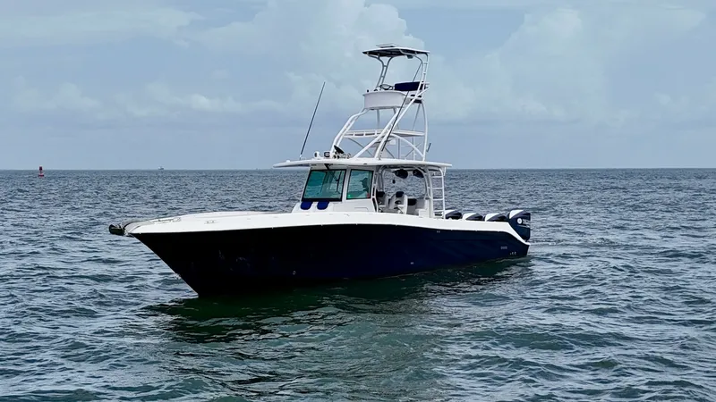 Slide: The Image of Starboard View of Hydra-Sports 4200 Siesta This image showcases the sleek design of the 2018 Hydra-Sports 4200 Siesta from the starboard side. The vessel features a robust center console with a distinctive tower for improved visibility and navigation. Its deep blue hull exudes elegance, while the - 7030853