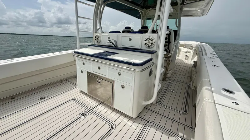 Slide: The Image of Spacious Aft Deck with Prep Station This 2018 Hydra-Sports 4200 Siesta features an expansive aft deck, ideal for both fishing and entertaining. The deck is equipped with a well-appointed prep station, complete with storage drawers and a cooler, enhancing functionality. The sleek design and - 7030832