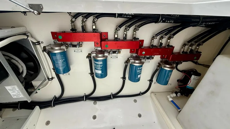 Slide: The Image of Engine Compartment Fuel Filtration System This image showcases the advanced fuel filtration system in the engine compartment of the 2018 Hydra-Sports 4200 Siesta. The neatly organized setup features multiple high-performance Yamaha filters, ensuring optimal fuel quality for superior engine perfor - 7030841