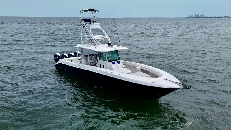 Slide: The Image of Aerial View of 4200 Siesta Bow This image showcases the sleek and spacious bow of the 2018 Hydra-Sports 4200 Siesta. With its aerodynamic design and sturdy construction, the vessel is equipped with ample seating and a robust T-top for shade and protection. The multiple outboard engines - 7030848