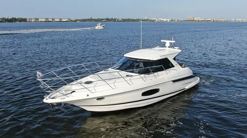 Slide: The Image of Bow and Starboard Side View This image showcases the sleek bow and starboard side of the 2014 Regal 46 Sport Coupe. The streamlined design and expansive windows offer a modern aesthetic, while the stainless steel railings add both safety and style. Its smooth hull and elegant lines - 6857481